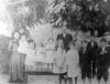 Fourth child from left; standing on bench